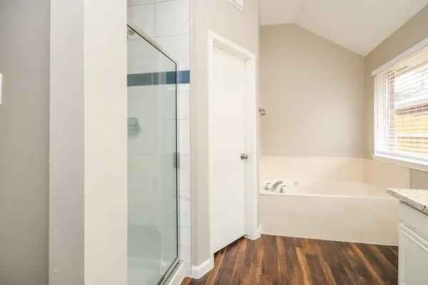 a bathroom with a bathtub and a window