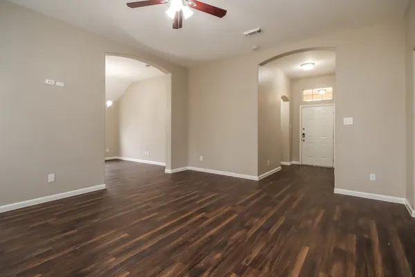 wooden floor in an empty room with a mirror