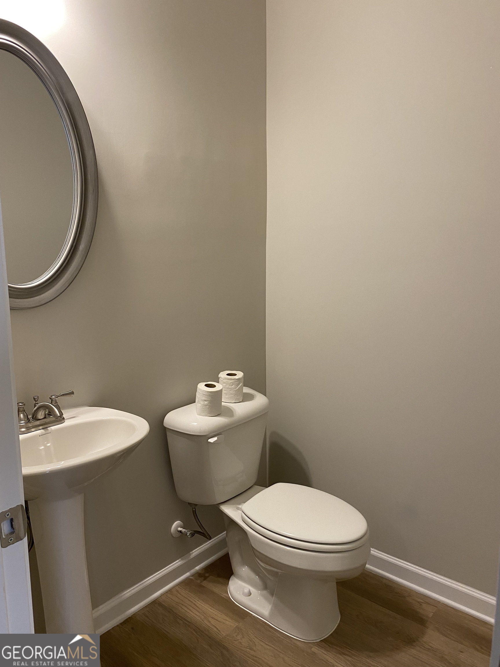 216 Finley Drive Commerce, GA 30529 - Photo 17 of 22 a white toilet sitting next to a bathroom sink