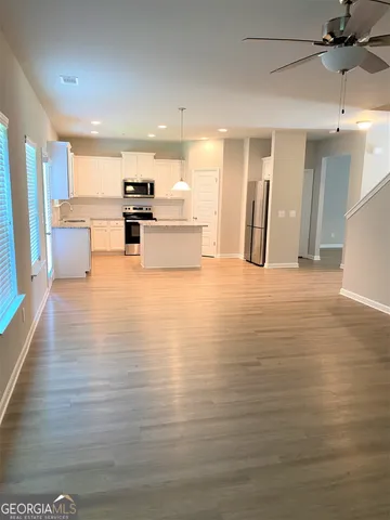 a view of kitchen with stainless steel appliances refrigerator and microwave