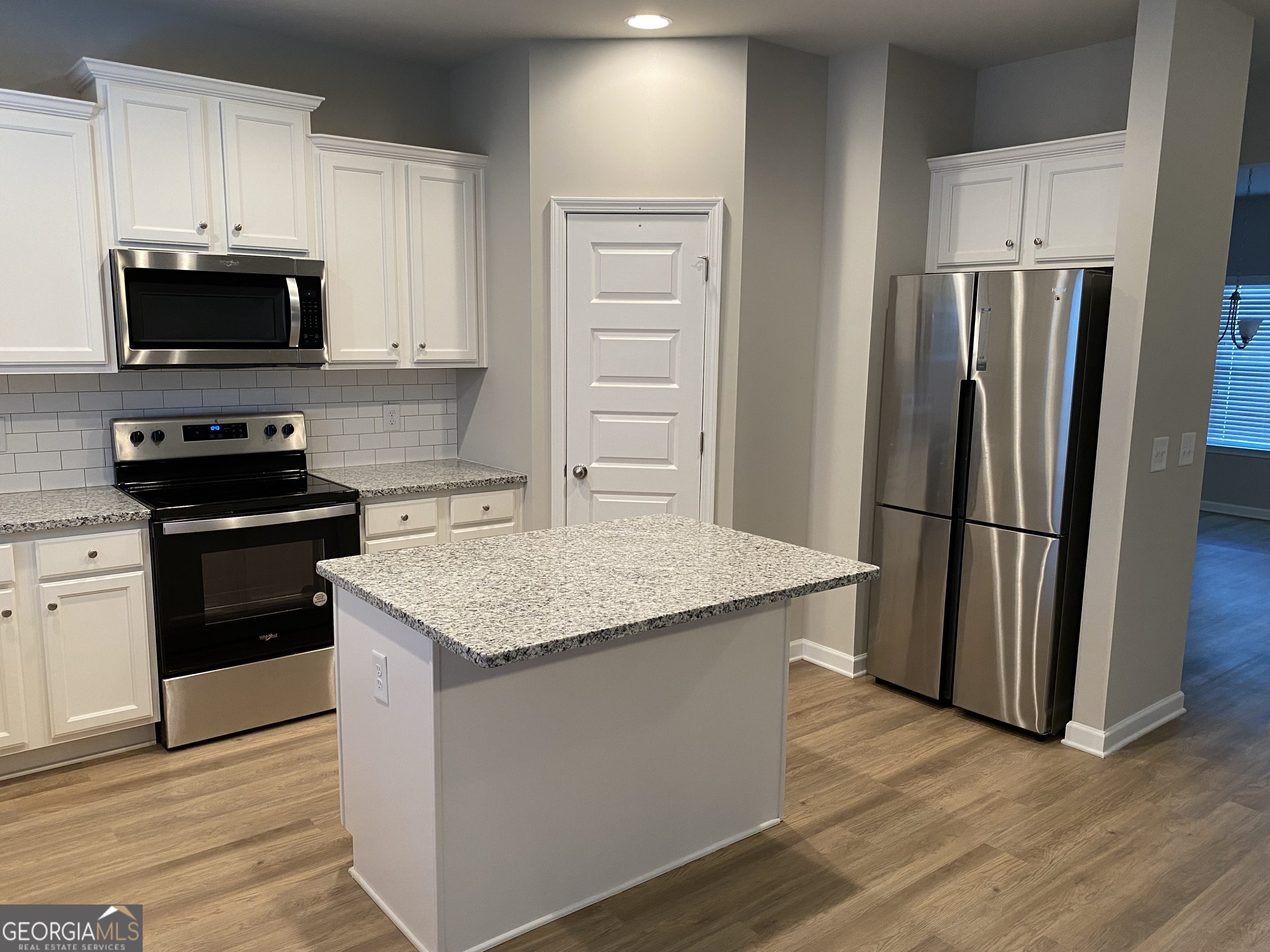 216 Finley Drive Commerce, GA 30529 - Photo 3 of 22 a kitchen with stainless steel appliances kitchen island granite countertop a refrigerator stove and microwave