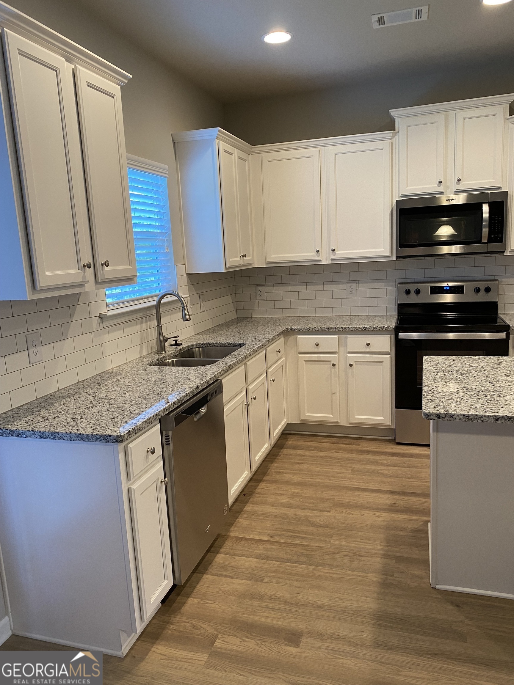 216 Finley Drive Commerce, GA 30529 - Photo 4 of 22 a kitchen with stainless steel appliances granite countertop a sink stove and cabinets