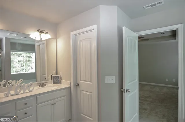 a bathroom with a double vanity sink and mirror with shower
