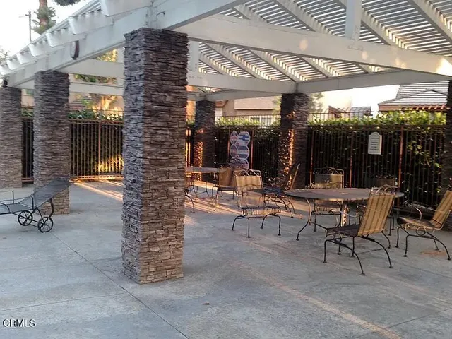 a view of a patio with dining table and chairs