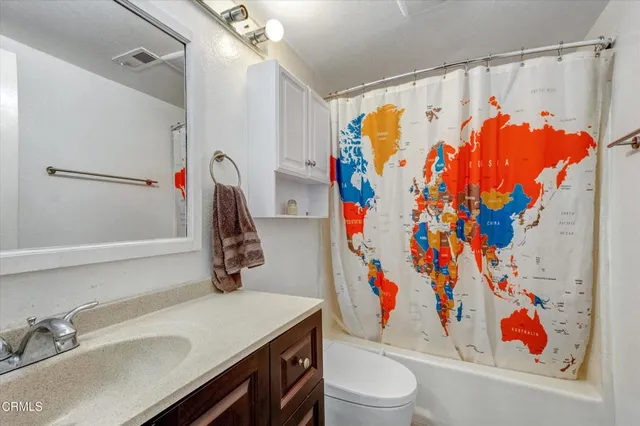 a bathroom with a sink a mirror and a shower curtain