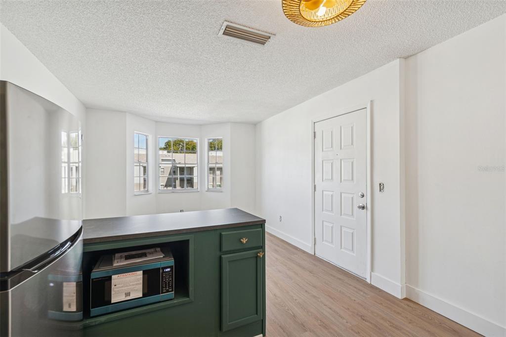 4511 South Oak Drive, Unit R32A Tampa, FL 33611 - Photo 13 of 27 a view of an oven and wooden floor