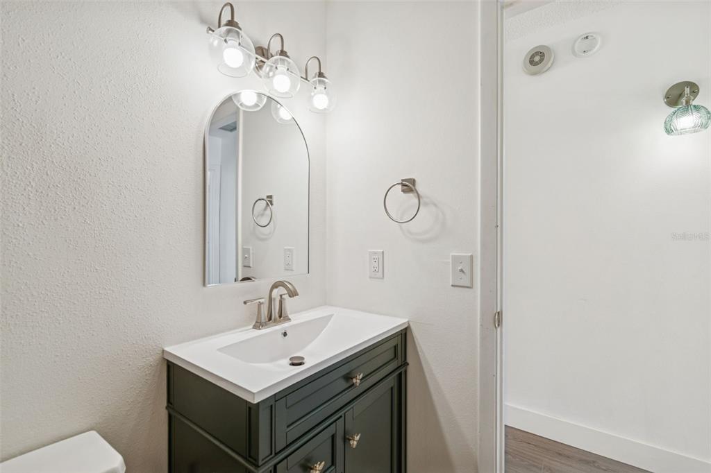 4511 South Oak Drive, Unit R32A Tampa, FL 33611 - Photo 17 of 27 a bathroom with a sink and a mirror