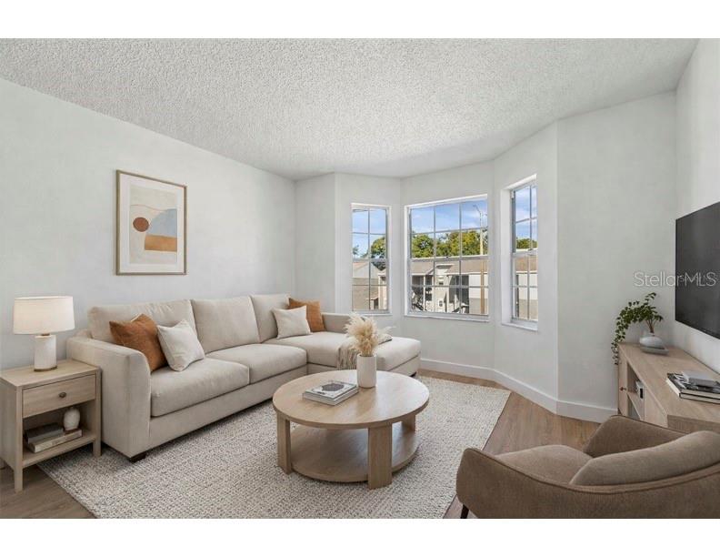 4511 South Oak Drive, Unit R32A Tampa, FL 33611 - Photo 2 of 27 a living room with furniture and a flat screen tv