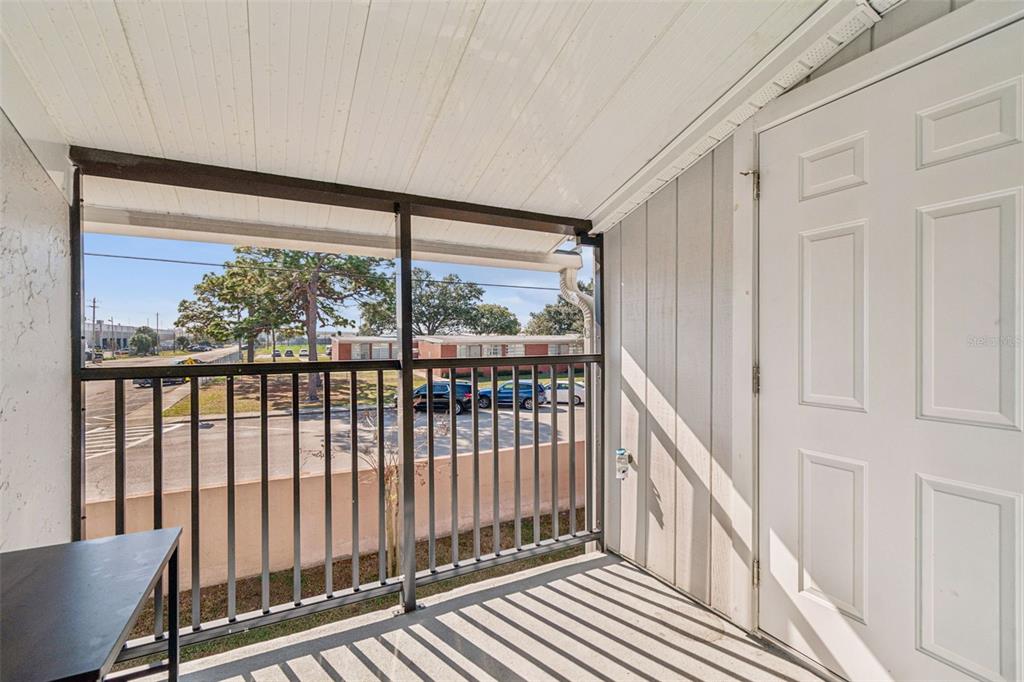 4511 South Oak Drive, Unit R32A Tampa, FL 33611 - Photo 22 of 27 a view of a balcony with wooden floor