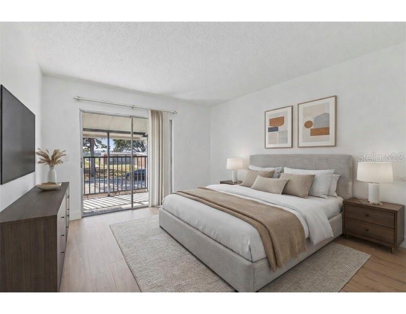 4511 South Oak Drive, Unit R32A Tampa, FL 33611 - Photo 3 of 27 a bedroom with a large bed and a window