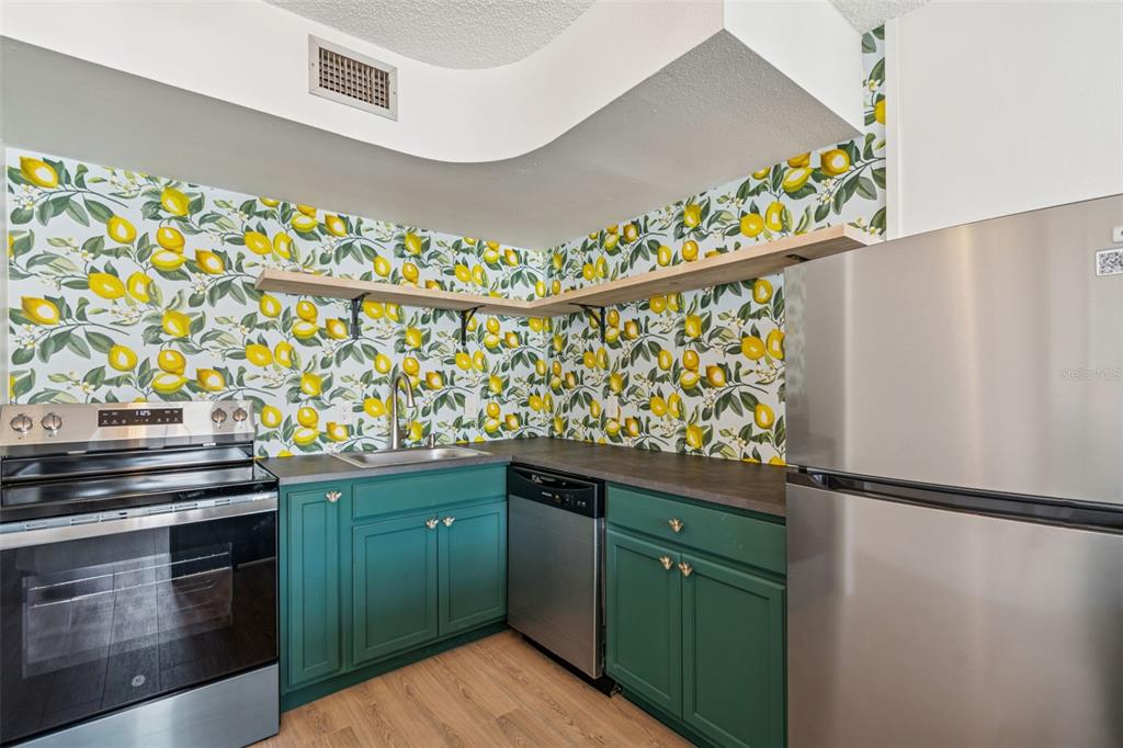 4511 South Oak Drive, Unit R32A Tampa, FL 33611 - Photo 4 of 27 a kitchen with granite countertop a stove and a sink