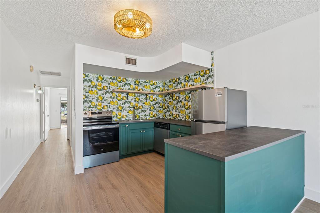 4511 South Oak Drive, Unit R32A Tampa, FL 33611 - Photo 9 of 27 a kitchen with stainless steel appliances granite countertop a refrigerator and a stove