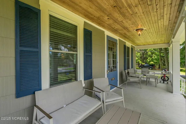 a balcony with furniture and a potted plant