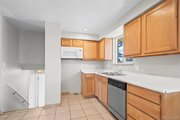 a kitchen with a sink cabinets and window