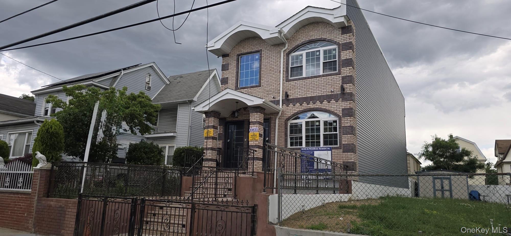 108-33 164th Street Queens, NY 11433 - Photo 2 of 20 a front view of a house with glass windows