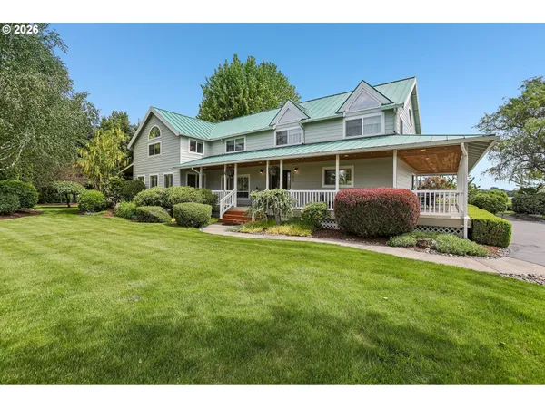 a front view of house with yard and outdoor seating