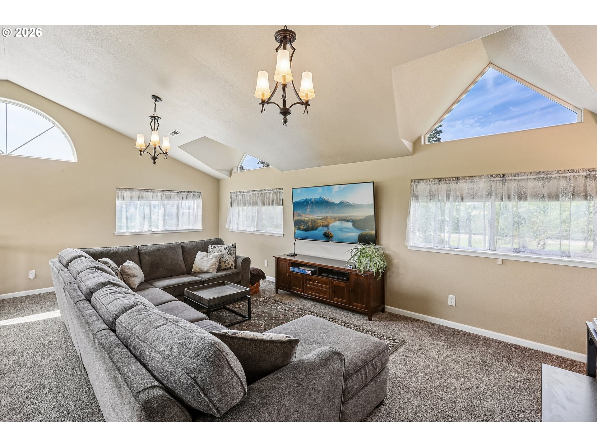 298 Roberson Road Woodland, WA 98674 - Photo 16 of 48 a living room with furniture a chandelier and a large window