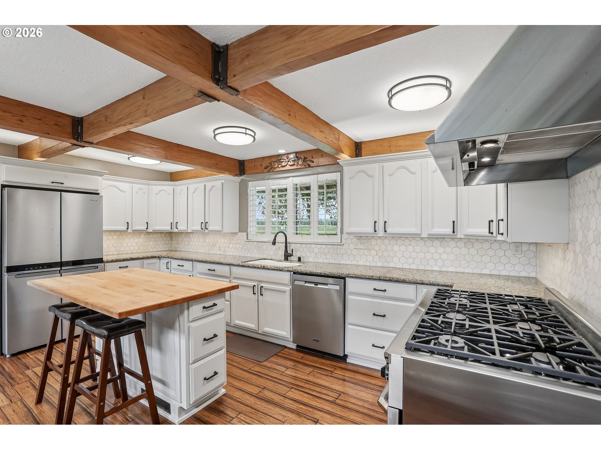 298 Roberson Road Woodland, WA 98674 - Photo 8 of 48 a kitchen that has a lot of cabinets in it and wooden floors