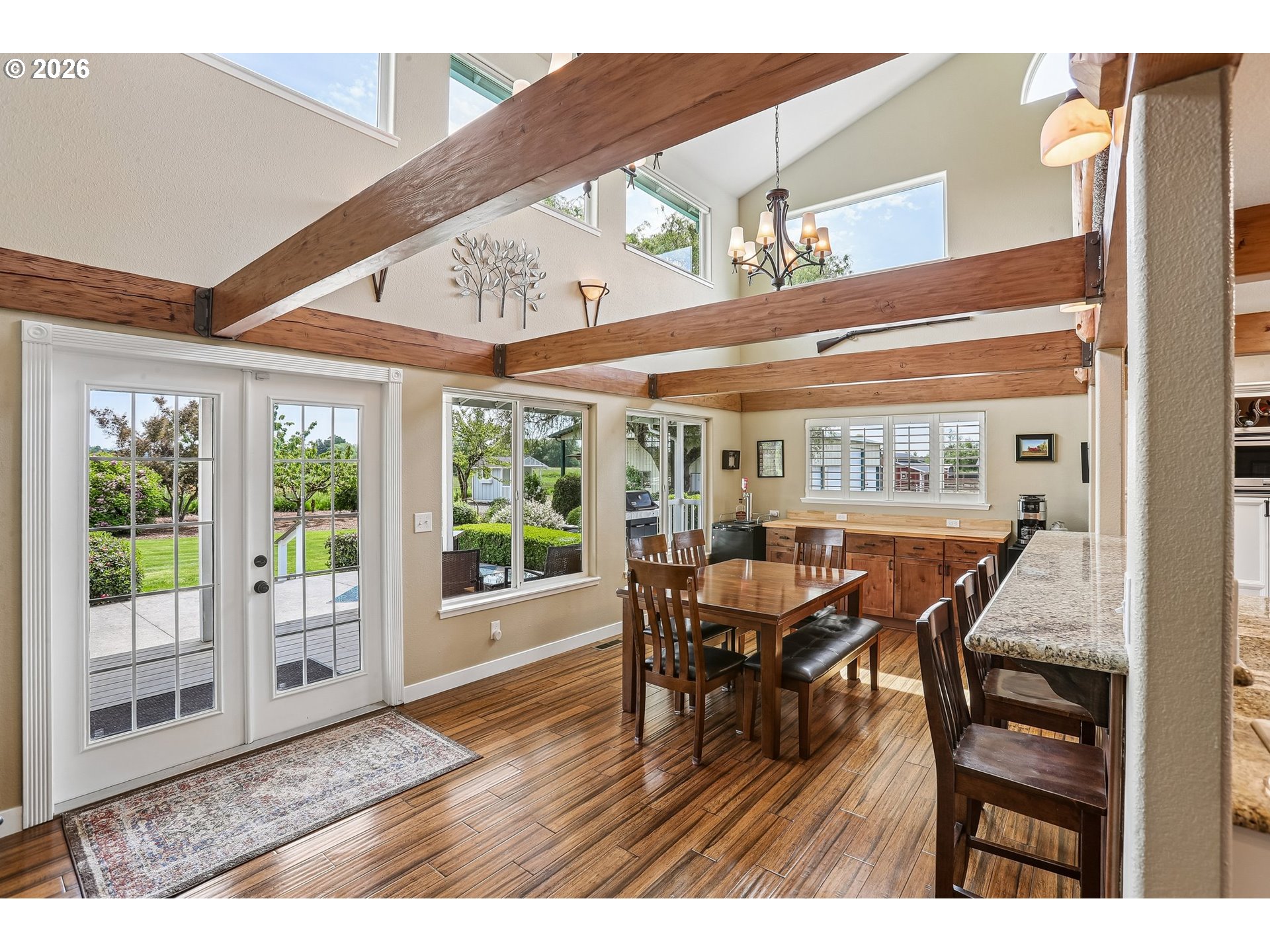 298 Roberson Road Woodland, WA 98674 - Photo 9 of 48 a dining room with furniture large windows and a chandelier