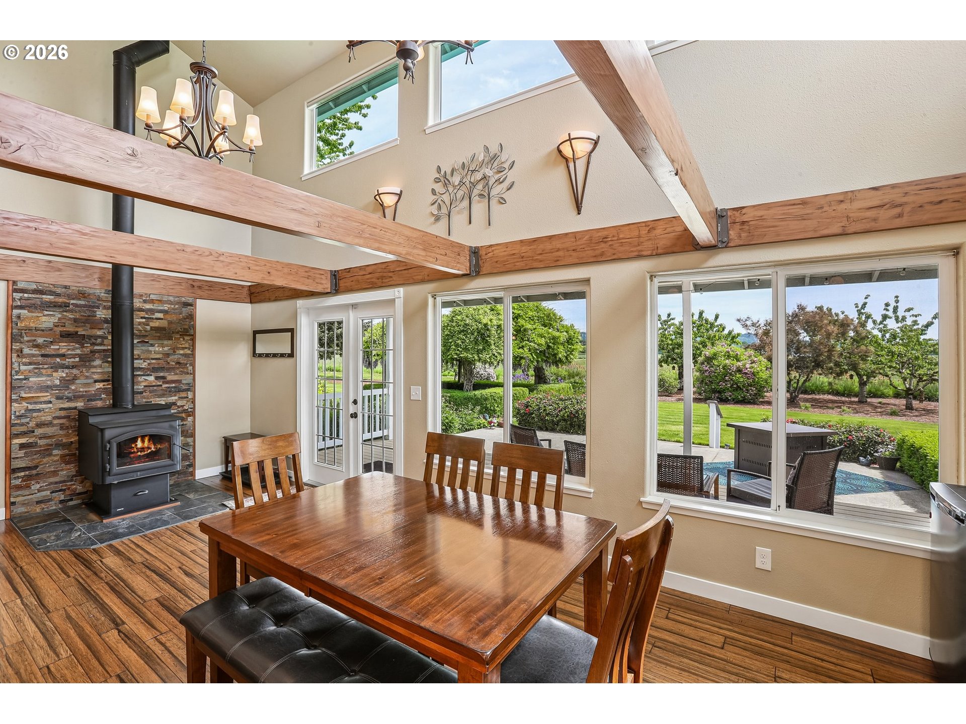 298 Roberson Road Woodland, WA 98674 - Photo 10 of 48 a view of a dining room with furniture large windows and wooden floor
