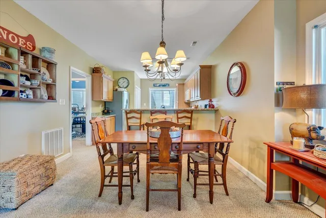 a dining room with furniture and a clock