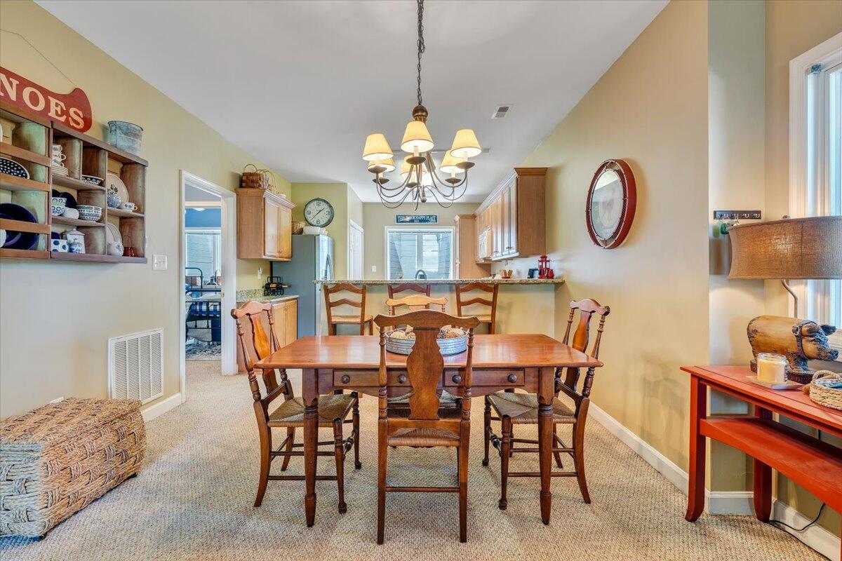 1209 Mariners Way, Unit 69 Huddleston, VA 24104 - Photo 13 of 72 a view of a dining room with furniture and chandelier
