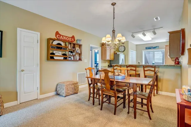 a view of a dining room with furniture and a large window