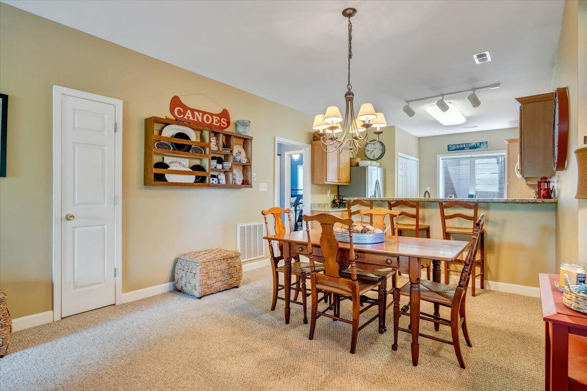 1209 Mariners Way, Unit 69 Huddleston, VA 24104 - Photo 14 of 72 a view of a dining room with furniture and a chandelier