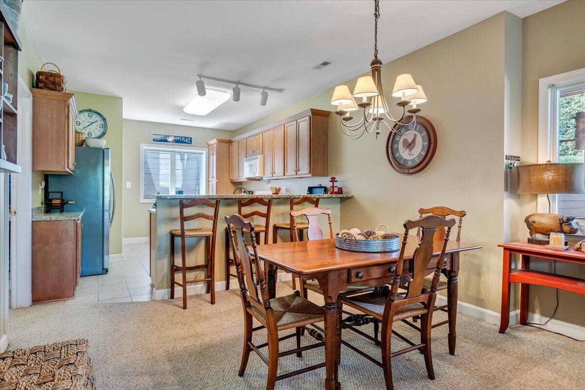 1209 Mariners Way, Unit 69 Huddleston, VA 24104 - Photo 15 of 72 a dining room with furniture and a clock