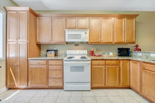 a kitchen with appliances cabinets and a sink