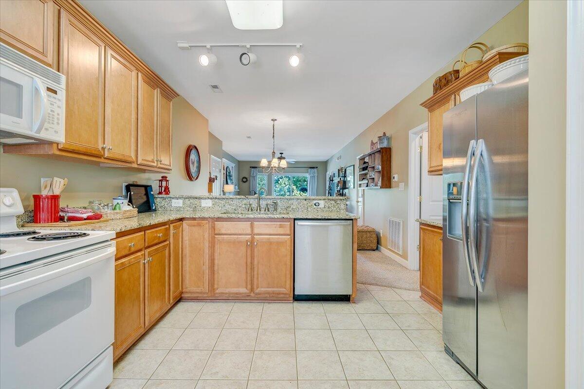 1209 Mariners Way, Unit 69 Huddleston, VA 24104 - Photo 20 of 72 a kitchen with stainless steel appliances granite countertop a refrigerator a sink dishwasher and white cabinets with wooden floor