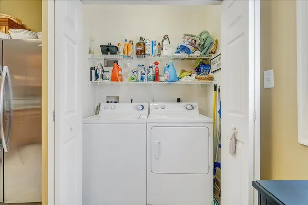a spacious bathroom with a granite countertop toilet a sink and a mirror