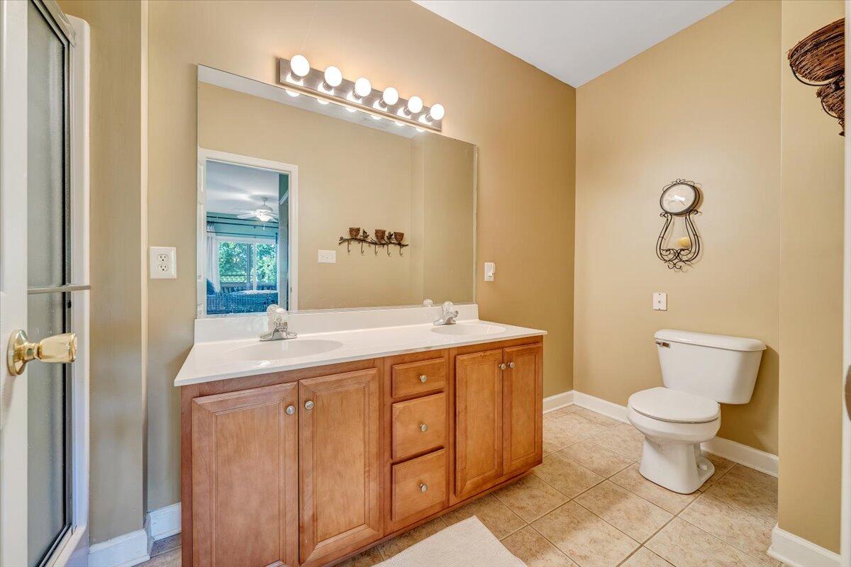 1209 Mariners Way, Unit 69 Huddleston, VA 24104 - Photo 29 of 72 a spacious bathroom with a granite countertop toilet a sink and a mirror