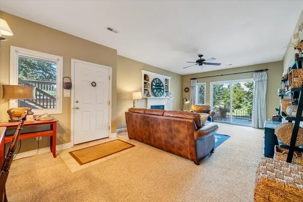 a living room with furniture a large window and a flat screen tv