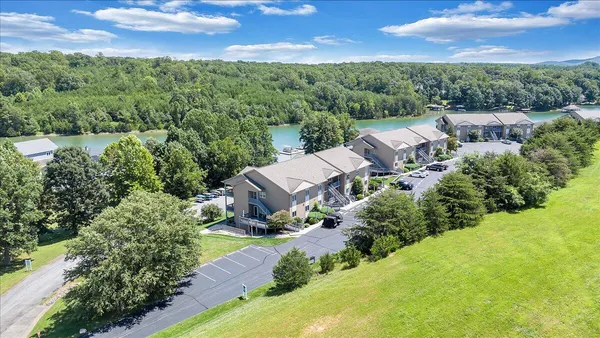a view of a house with a yard and lake view