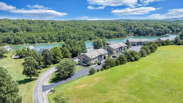 an aerial view of multiple houses with a yard