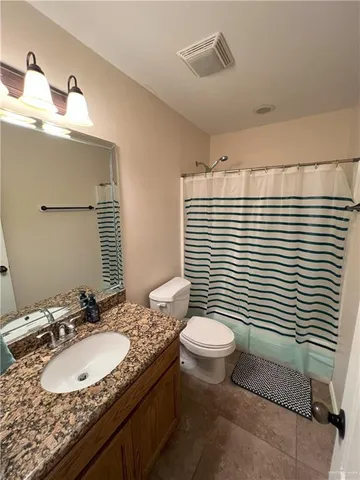 a bathroom with a sink toilet and mirror