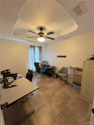 a living room with furniture and a ceiling fan