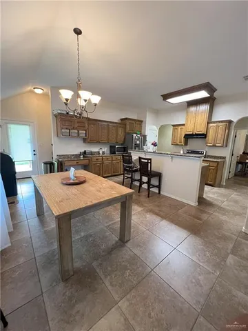 a large kitchen with a table and chairs