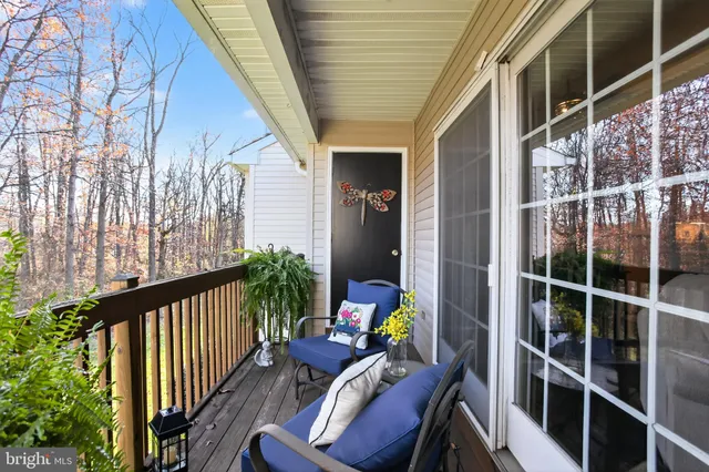a view of a balcony with furniture and wooden deck