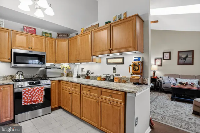 a kitchen with stainless steel appliances granite countertop a sink stove and cabinets