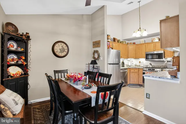 a view of a dining room with furniture and a chandelier