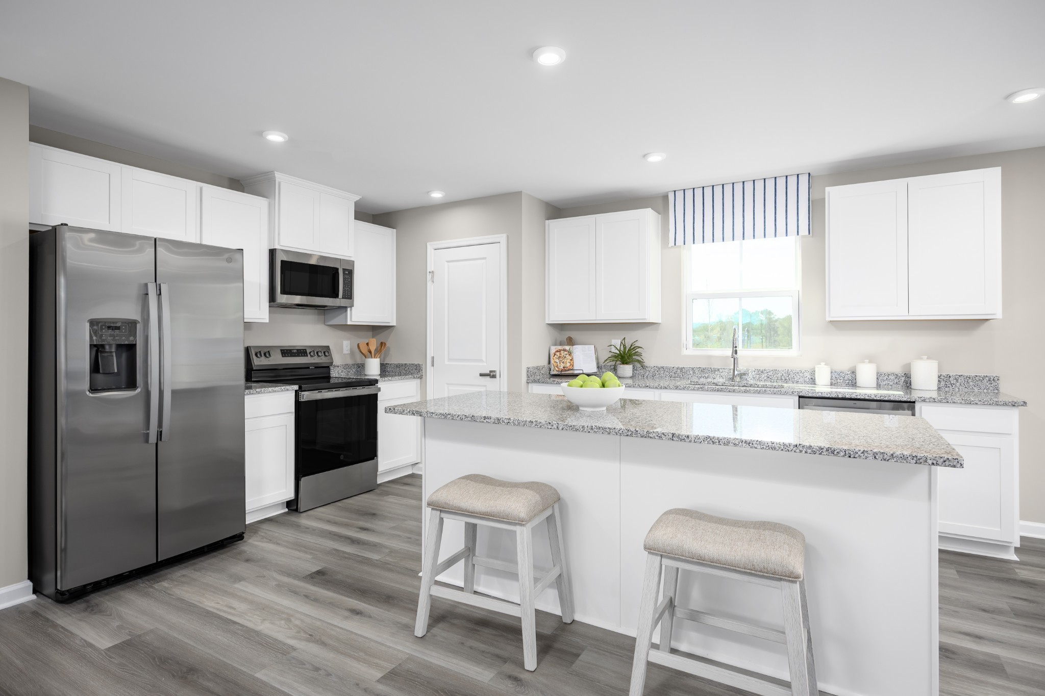 600 Merle Avenue Franklin, KY 42134 - Photo 3 of 14 a kitchen with kitchen island granite countertop a sink cabinets stainless steel appliances and a window