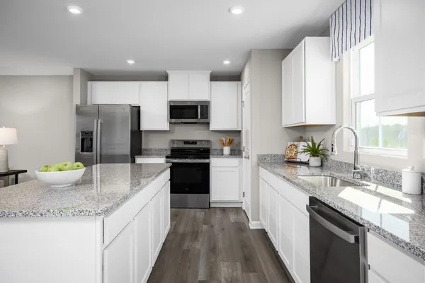 a kitchen with a sink stove and refrigerator