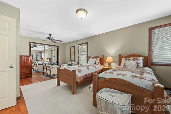 a bedroom with two beds and painting on the wall