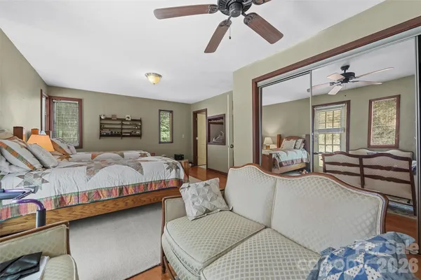 a bedroom with a bed a couch and dresser