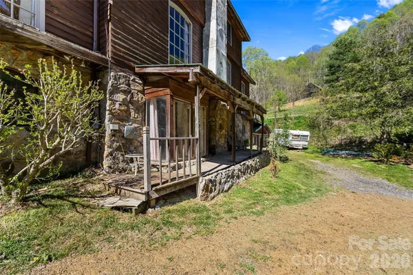a view of a house with a small yard and wooden fence