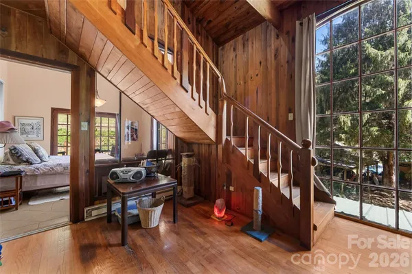 a living room with chairs and stairs
