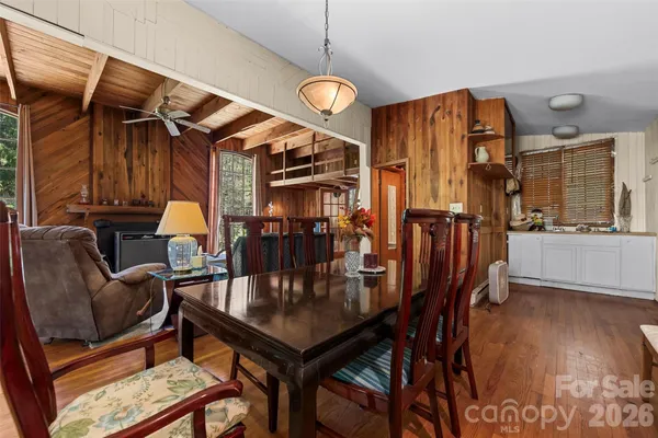 a dining room with furniture and wooden floor