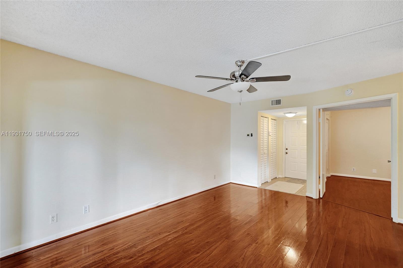 9833 Westview Drive, Unit 819 Coral Springs, FL 33076 - Photo 12 of 47 wooden floor in an empty room